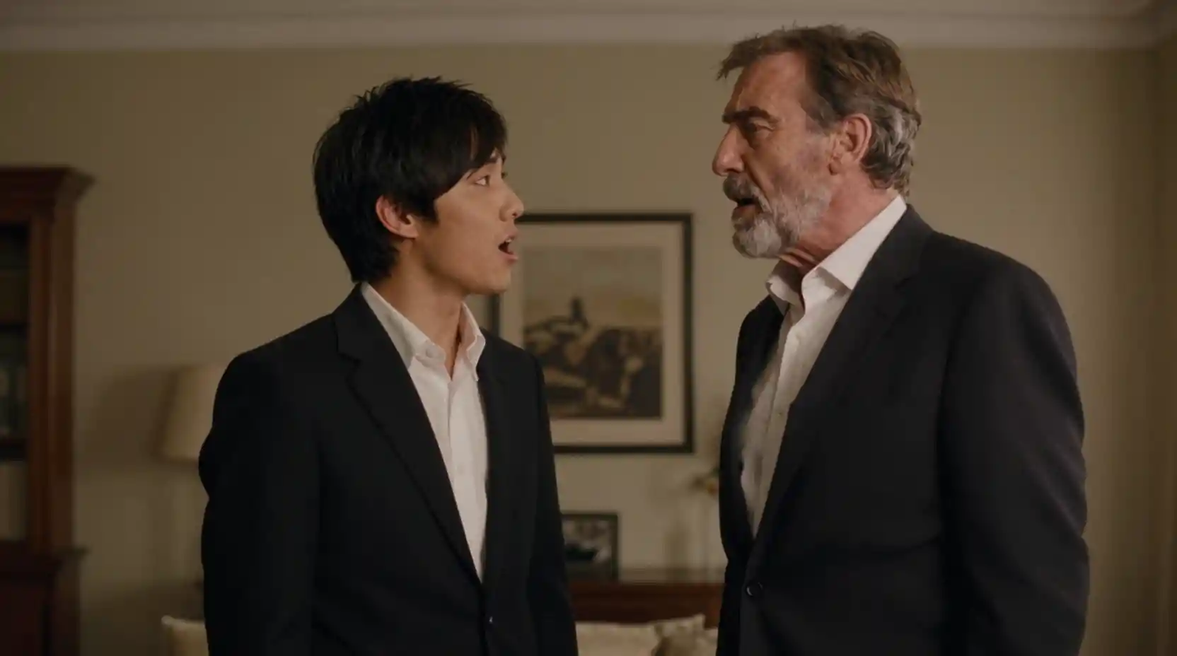 Two men singing together in a melancholic apartment scene