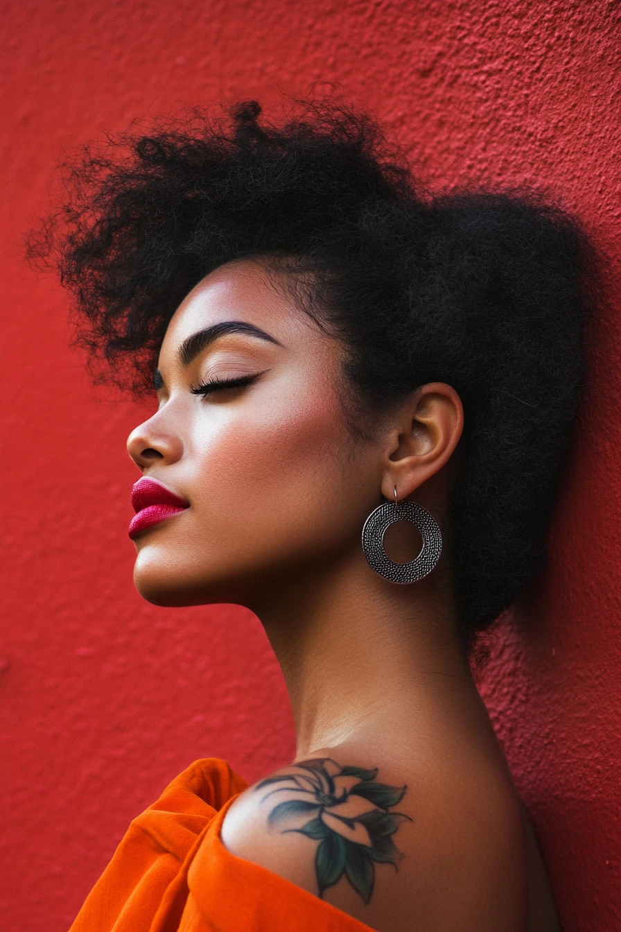 Profile portrait of a black woman with floral tattoo