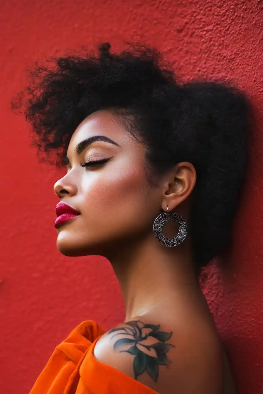 Profile portrait of a black woman with floral tattoo