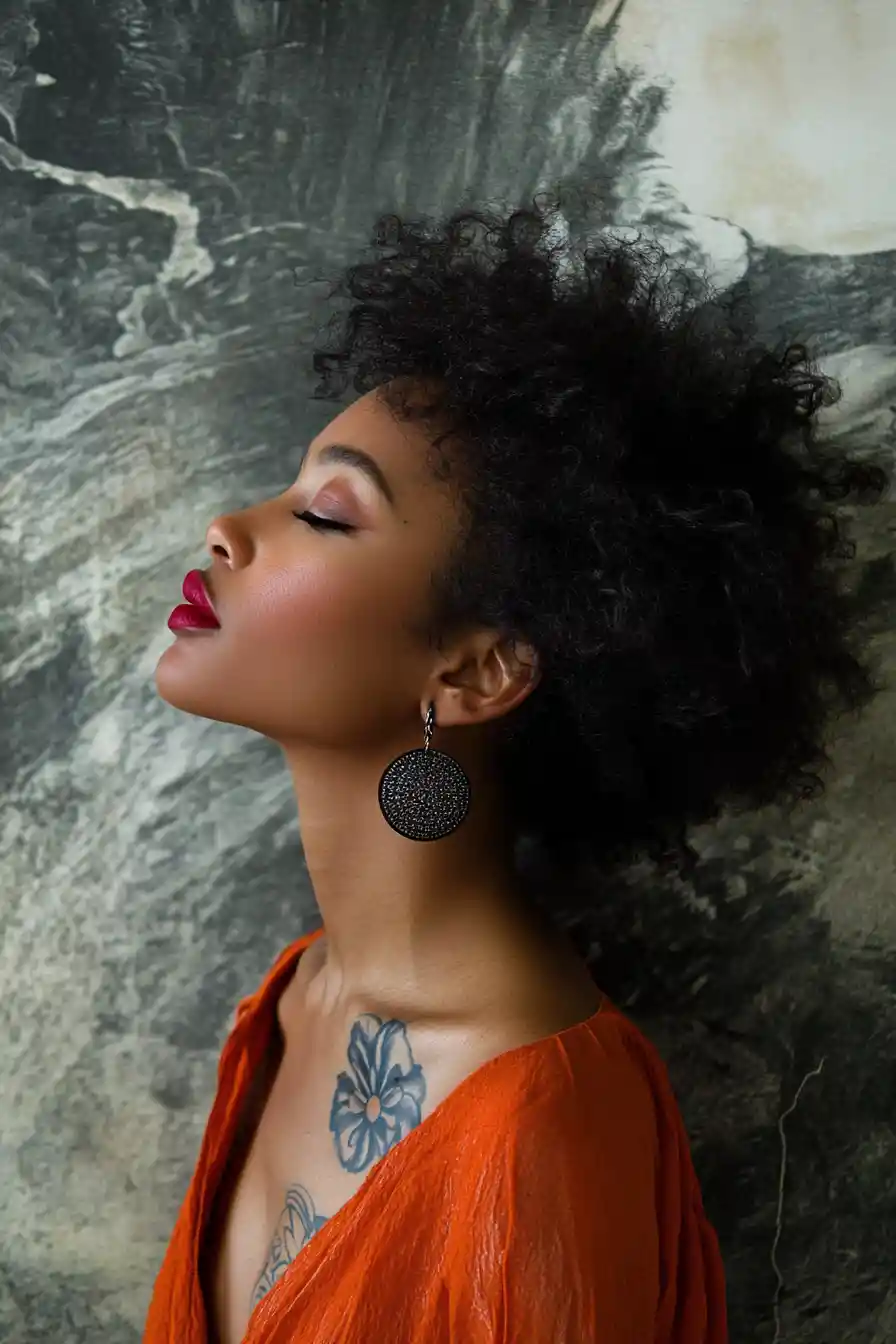 Charcoal profile portrait of a black woman with orange drape