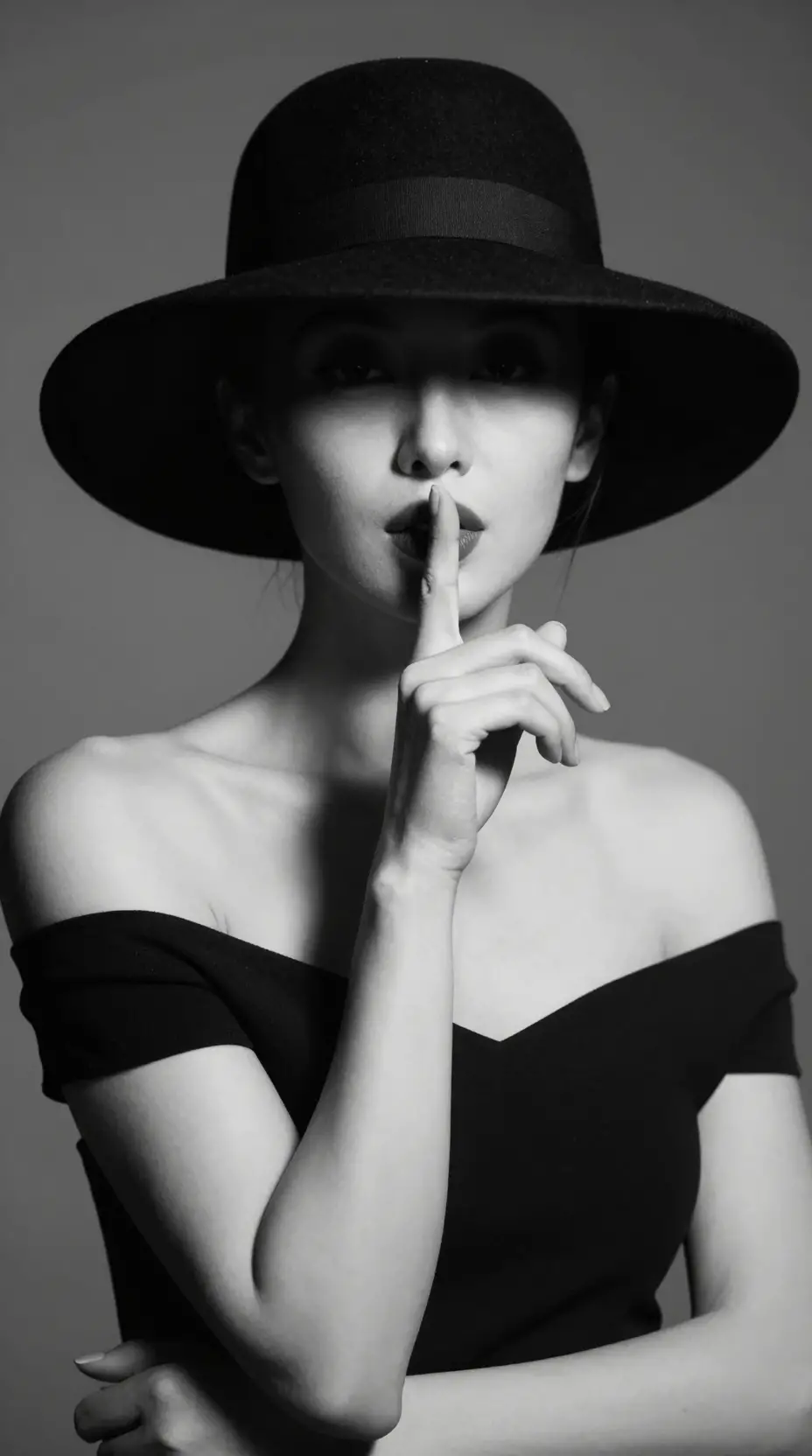 Mysterious black and white portrait of a woman in hat