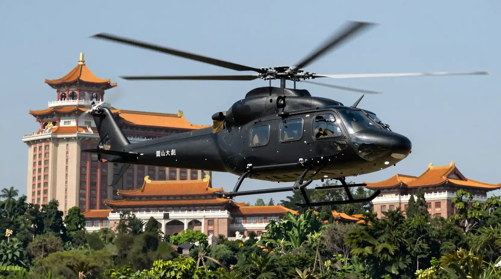Black helicopter hovering before grand Chinese palace hotel