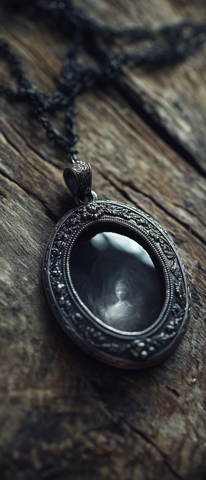 Antique silver locket glowing with white light on wood