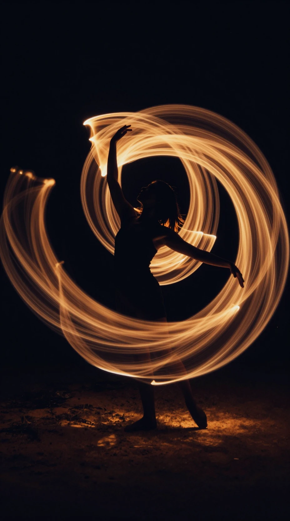 Silhouetted dancer wrapped in swirling golden light trails