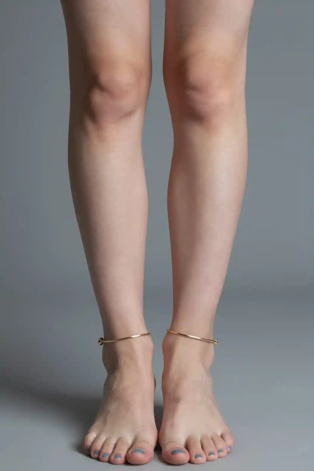 Close up of girl bare feet with blue toenails