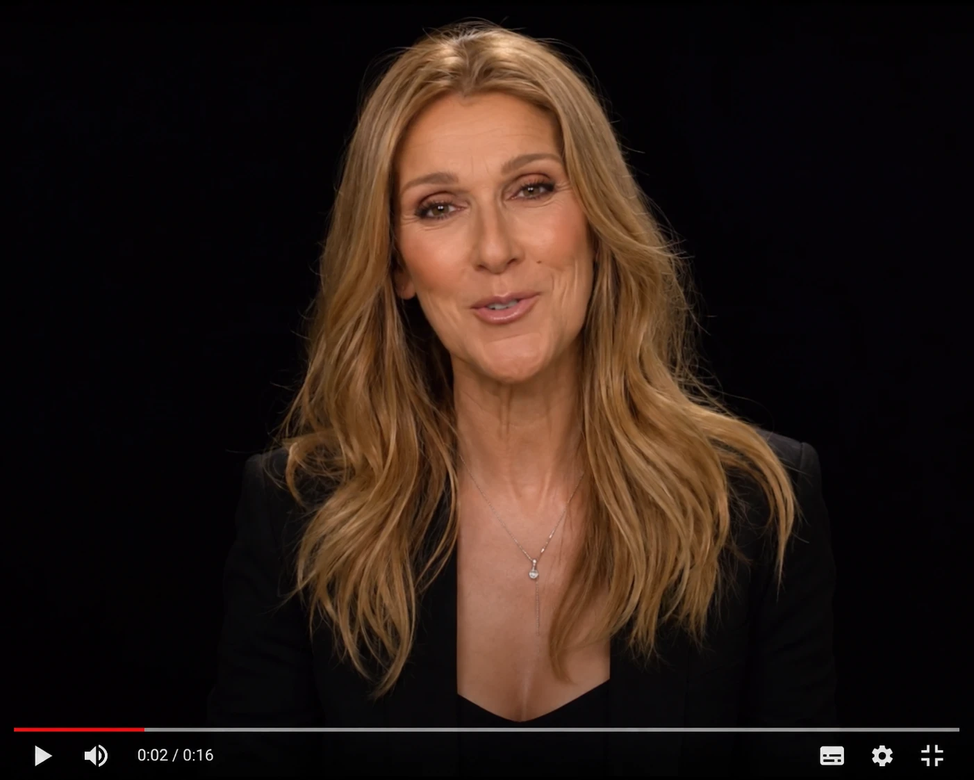 Celine Dion bust portrait against deep black background