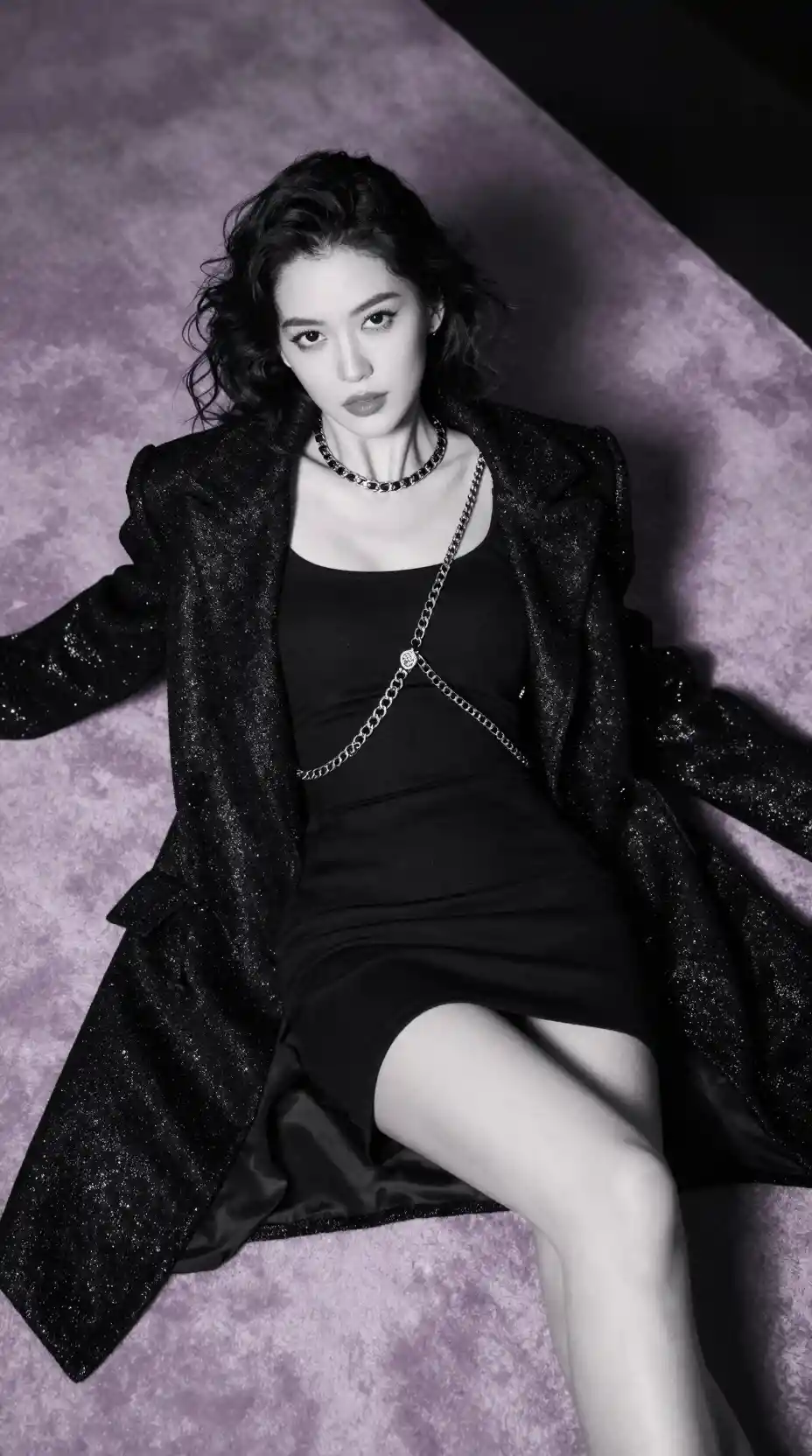 Overhead black and white portrait of glamorous woman on carpet