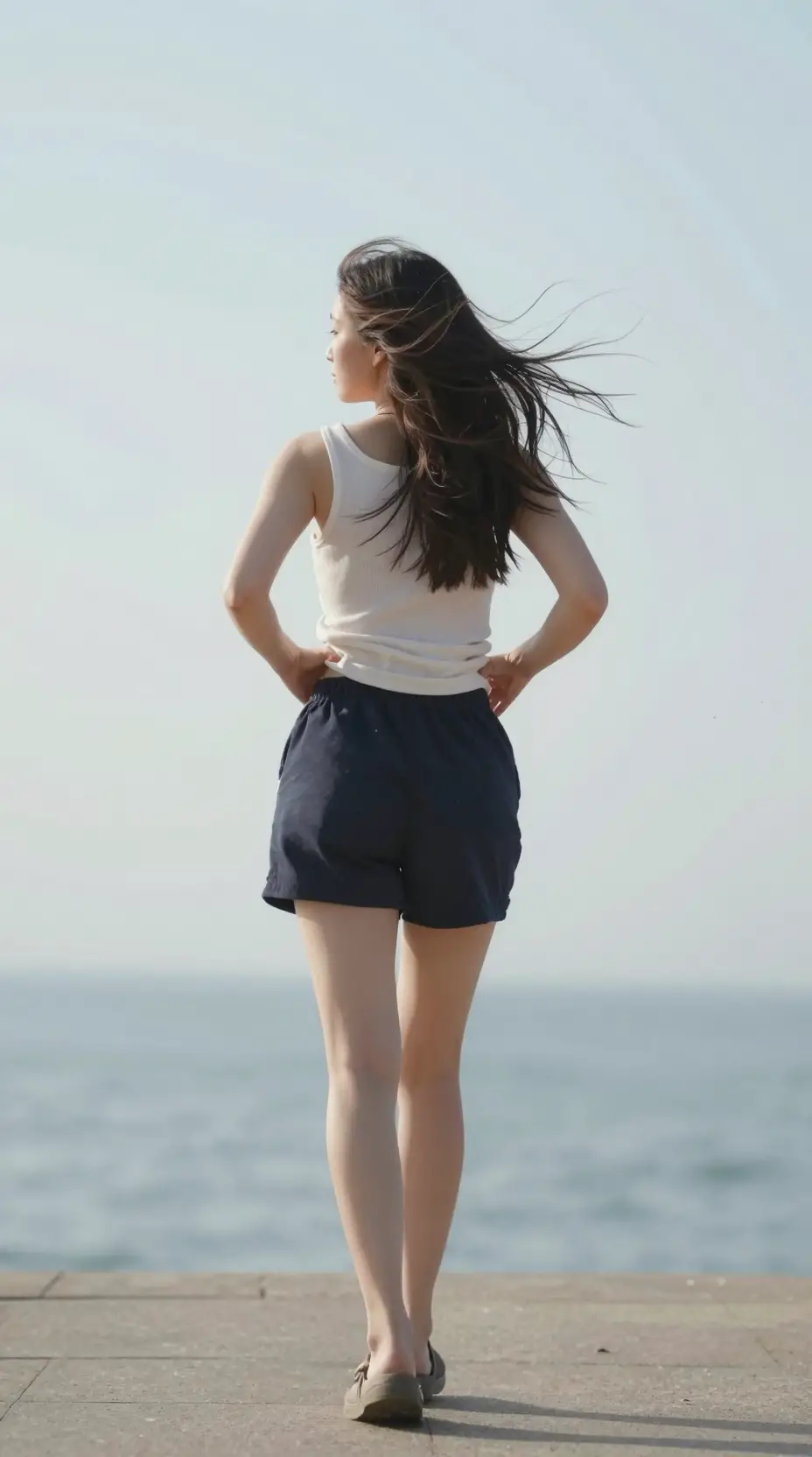 Woman walking away as her outfit subtly shifts in motion