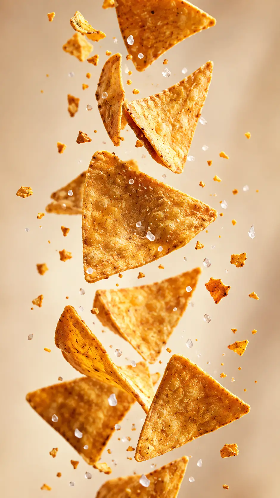 Golden tortilla chips falling in dynamic vertical motion
