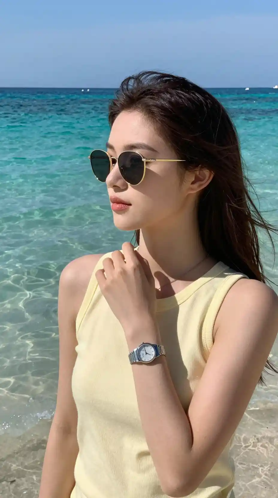 A relaxed figure enjoys clear turquoise water beneath a soft blue sky