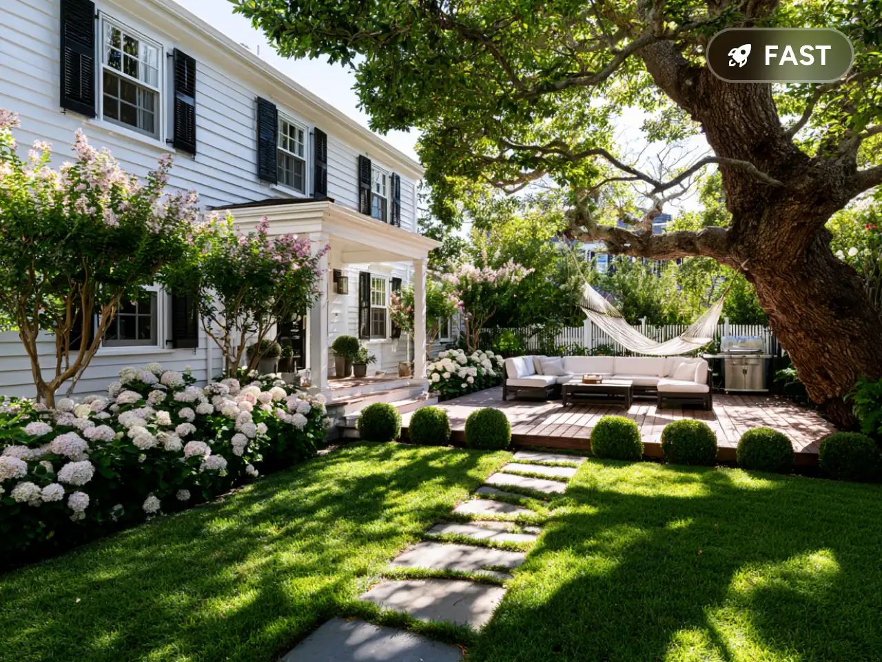 a white house with lawn deck furniture and hydrangeas