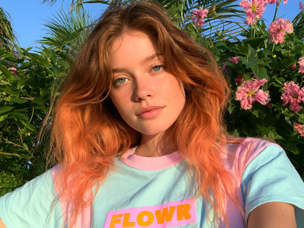 realistic portrait of a young woman in a flower garden