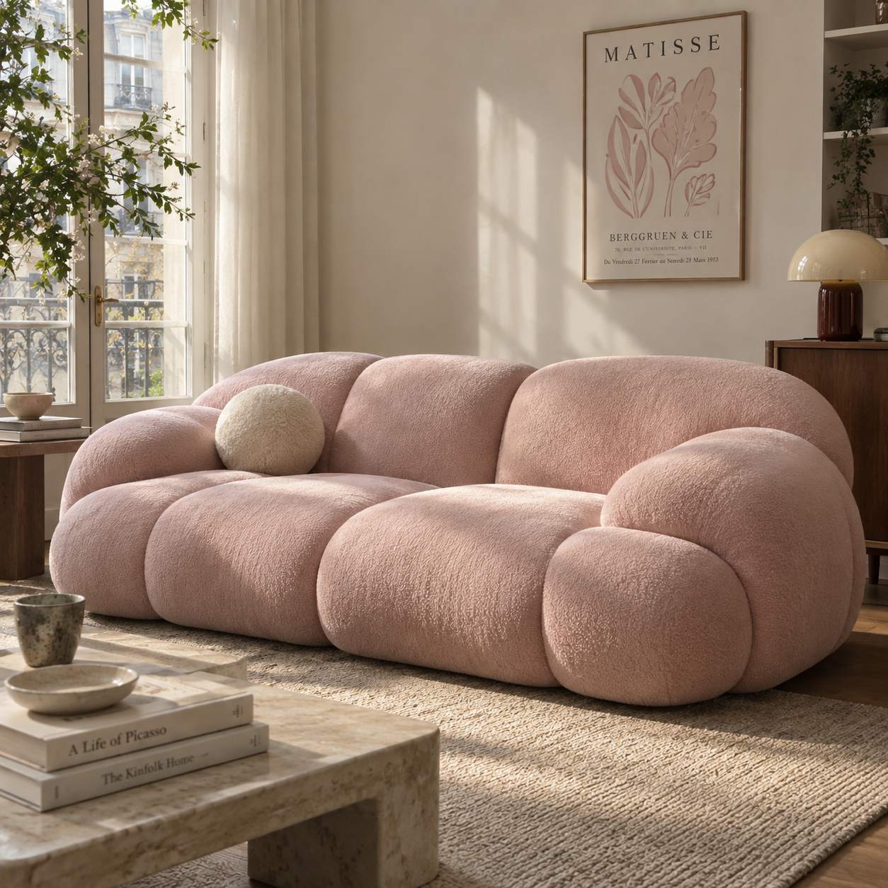 Light pink boucle sofa in a sunlit modern living room