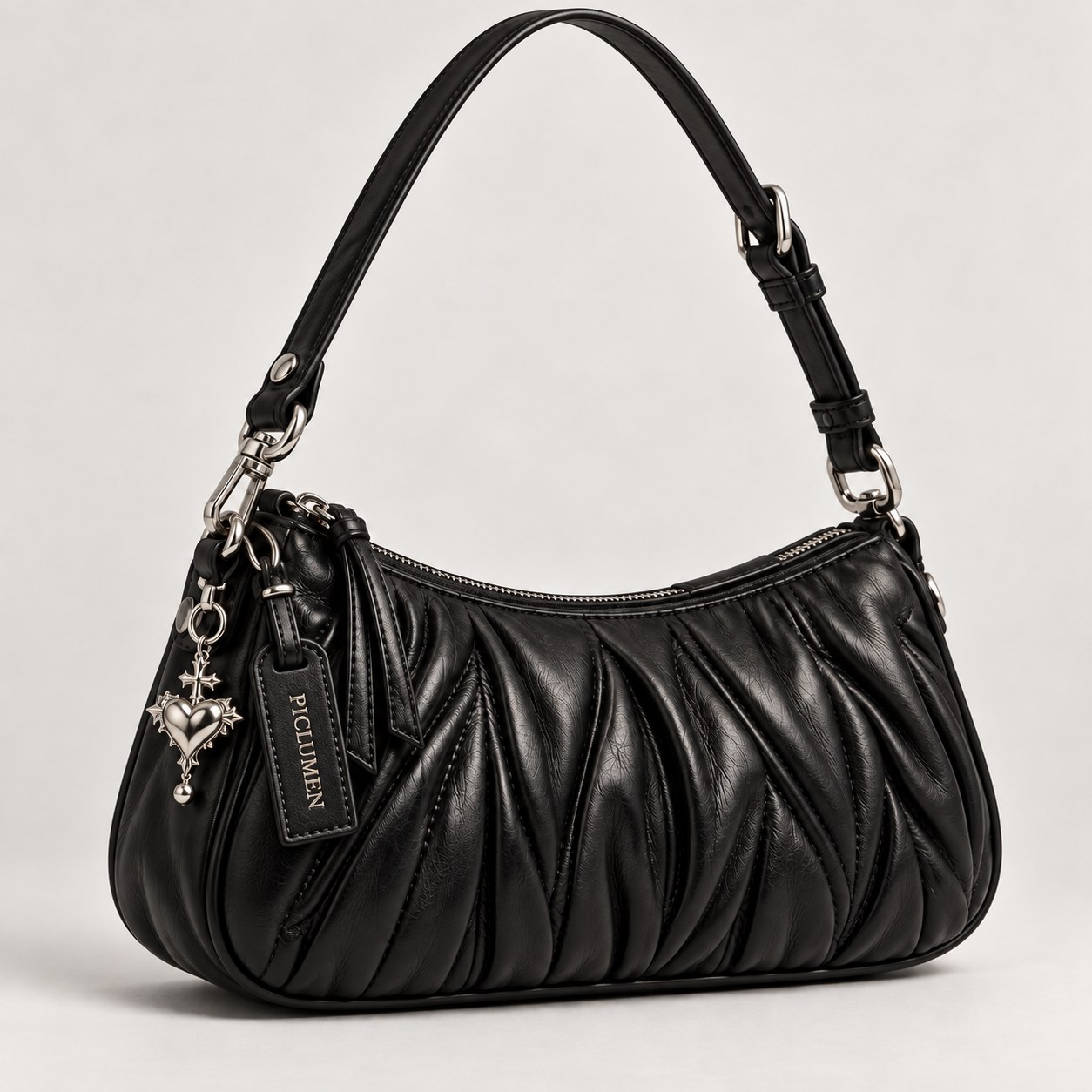 Black ruched leather shoulder bag with silver hardware and a heart charm