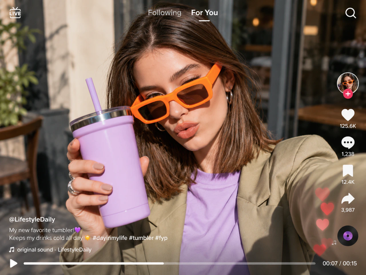 a woman holds a tumbler in a social video
